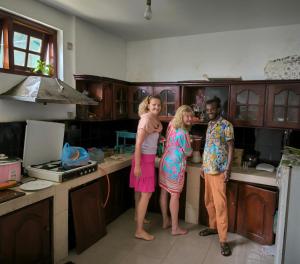 a group of three people standing in a kitchen at Villa The View in Nuwara Eliya +41 photos