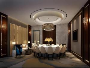 a dining room with a table and white chairs at Jinjiang Metropolo Hotel - Taiyuan Economic Development Zone in Taiyuan