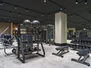 a gym with several rows of exercise bikes and weights at Thompson Palm Springs, By Hyatt in Palm Springs