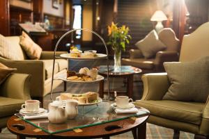 a tray of food on a table in a living room at Leonardo Boutique Huntingtower Perth in Perth