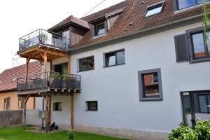 a house with balconies on the side of it at Gites Les Terrasses du Wineck in Katzenthal