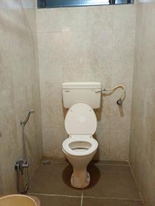 a bathroom with a toilet and a sink at Alibag Beach Stay- The Grantley Hotel in Alibag