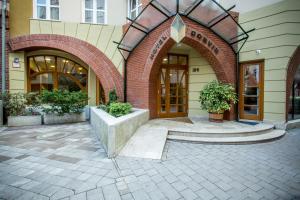 a building with two arches on the side of it at Corvin Hotel Budapest Corvin Wing in Budapest