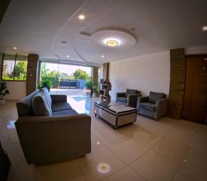 a living room with two couches and a table at Eldon Suites & Apartments By MOKAWA in Nairobi