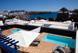 a view from the roof of a building with a swimming pool at Villas Coloradas in Playa Blanca