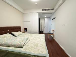 Ένα ή περισσότερα κρεβάτια σε δωμάτιο στο Huigu Apartment