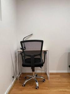 a black chair sitting in front of a desk at Executive family house w/ 5BR in Belmont +73 photos