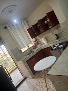an aerial view of a kitchen with a white table at AMTWAPA 2 bedroom pure blissful apartment ready to accommodate you and your family friends or colleagues in Mtwapa