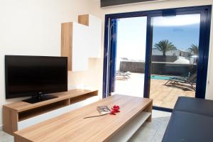 TV a/nebo společenská místnost v ubytování Villas Coloradas