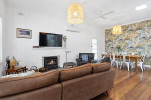a living room with a couch and a fireplace at Rapid Getaway - 4 Cygnet Place, Rapid Bay in Rapid Bay