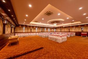 a large banquet hall with white tables and chairs at The Liverpool Hotels Marathahalli, Outer Ring Road in Bengaluru