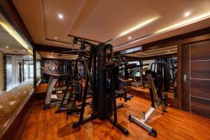 a gym with several treadmills and elliptical machines at The Liverpool Hotels Marathahalli, Outer Ring Road in Bengaluru