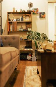 a living room with a couch and a plant at Như Là Home in Khu Chi Lăng