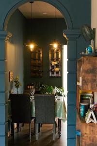 a dining room with a table and a blue wall at Như Là Home in Khu Chi Lăng +1 photo