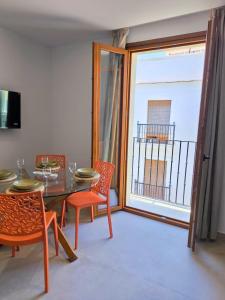 a dining room with a table and chairs and a window at El Jazmín del Patio in Nerja