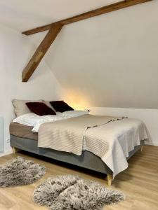 a bedroom with a large bed in a white wall at Mlýnská 53 in Kraslice