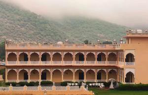 a large building with a mountain in the background at Horizon Banquet Pushkar - with Mountain View in Pushkar