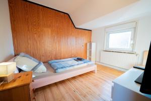 a bedroom with a bed with a wooden wall at Comfortable Apartment in Lauenburg Elbe in Lauenburg