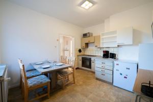 a kitchen with a table and chairs and a kitchen with white appliances at Comfortable Apartment in Lauenburg Elbe in Lauenburg