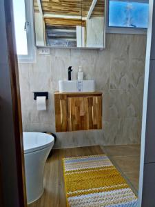 a bathroom with a sink and a toilet and a rug at Samui Tiny House villa Glamping, Seaview Sleeps 8 in Amphoe Koh Samui +40 photos