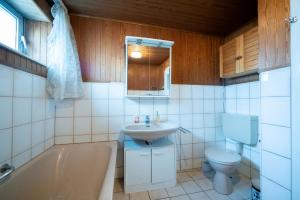 a bathroom with a tub and a sink and a toilet at Comfortable Apartment in Lauenburg Elbe in Lauenburg