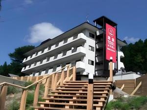 a building with a red sign in front of it at Kinugawa Niouson Plaza Hotel in Nikko