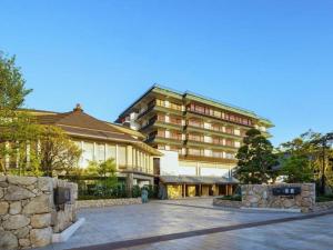 a large building with a stone wall in front of it at Shiratamano Yu Senkei in Shibata