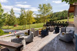 a patio with chairs and tables and a grill at Hotel Polar Star in Žabljak