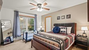 a bedroom with a bed and a ceiling fan at Mews Mountain House by AvantStay Walk to Beach Hot Tub Game Room in Albrightsville