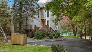 a house with a driveway in front of it at Emerald Bluff by AvantStay Lake Views Deck Fire Pit Game Room in Long Pond