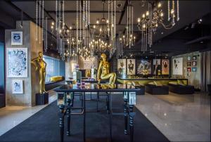 a room with a table and chandeliers at The Hulo Hotel & Gallery in Kuala Lumpur