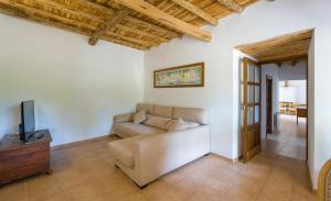 a living room with a couch and a television at Can Cama in Santa Gertrudis de Fruitera