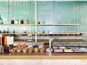 a bakery counter with donuts and other pastries at ibis budget Zurich City West in Zürich