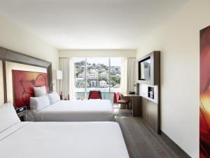 a hotel room with two beds and a window at Novotel Wellington in Wellington +35 photos