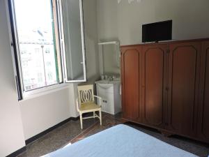 a bedroom with a tv on top of a wooden cabinet at Albergo La Vela in Rapallo