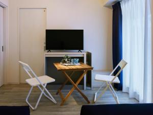 a living room with a table with two chairs and a television at Minn Umeda East in Osaka