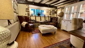 a bedroom with a bed and a desk and chairs at The Old Thatch - Hennock in Newton Abbot