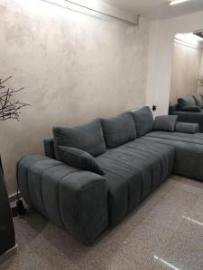 a large blue couch in a living room at Glow Sahara in Văleni