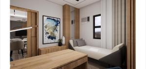 a living room with a white couch and a television at Novel Hotel Manila in Manila