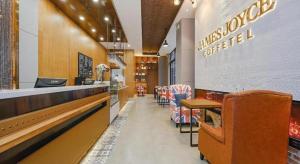 a fast food restaurant with a counter and chairs at James Joyce Coffetel Shenyang North Railway Station Qishan Road Metro Station in Shenyang