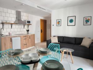 a living room with a couch and a table at El Jazmín del Patio in Nerja