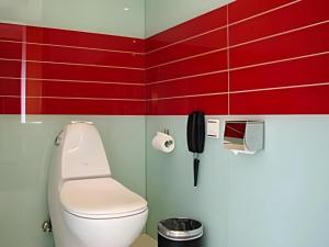 a red bathroom with a toilet and a phone at Tomolo Hotel Wuzhan Branch in Wuhan +39 photos