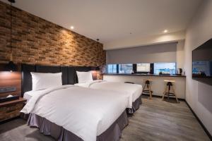 Postel nebo postele na pokoji v ubytování Goldinn Hotel