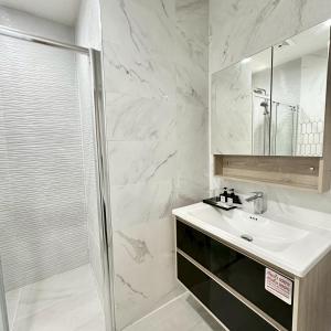 a white bathroom with a sink and a shower at J STAR in Jomtien Beach +55 photos