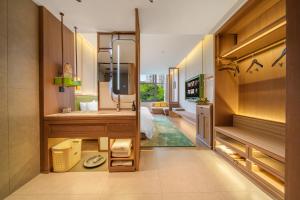 a room with a bedroom with a bed and a mirror at Chongqing Mansion Manyue Hotel in Chongqing