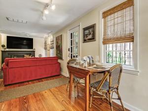 a living room with a red couch and a table at Courtyard Off Madison Square in Savannah