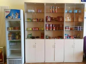 a white pantry with white doors and shelves at 7 Days Inn Shenyang Gugong Middle Street Pedestrian Street in Shenyang