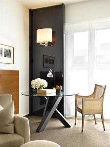 a dining room with a glass table and a chair at Grand Hyatt Berlin in Berlin +144 photos