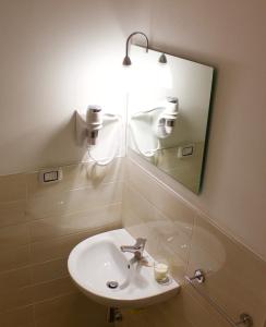 a bathroom with a sink and a mirror at Terra Lucana B&B in Matera