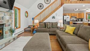 a living room with a couch and a fireplace at Lake Pool Access Game Room Firepit Deck Tawny and Peaceful by AvantStay in Arrowhead Lake